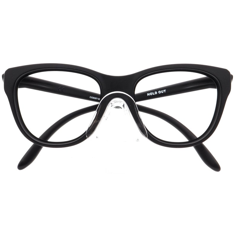 May include: Black eyeglasses with a cat-eye shape. The frames are matte black, and the lenses are clear. The nose pads are transparent. The text "HOLD OUT" is printed on the right arm of the glasses.