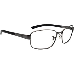 May include: Gunmetal Ray-Ban spectacles with rectangular lenses and black arms. The frames have a modern design, with the Ray-Ban logo on the temple. The spectacles are designed for vision correction.