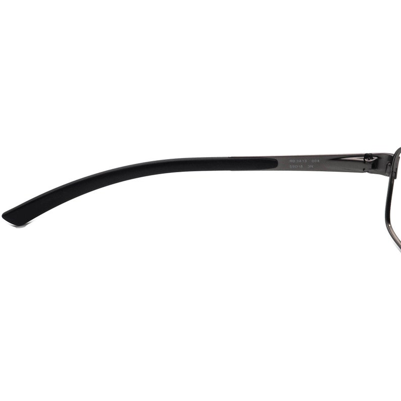 May include: Close-up of a pair of eyeglasses. The frame is a dark grey metal with a black curved temple arm. The temple arm has a black rubberised section for comfort. The text "RB 3413 004 55018 3N" is printed on the frame.