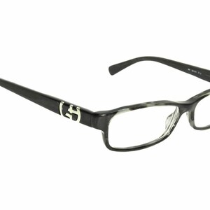 May include: Black and gray tortoiseshell eyeglasses with a silver logo on the side.