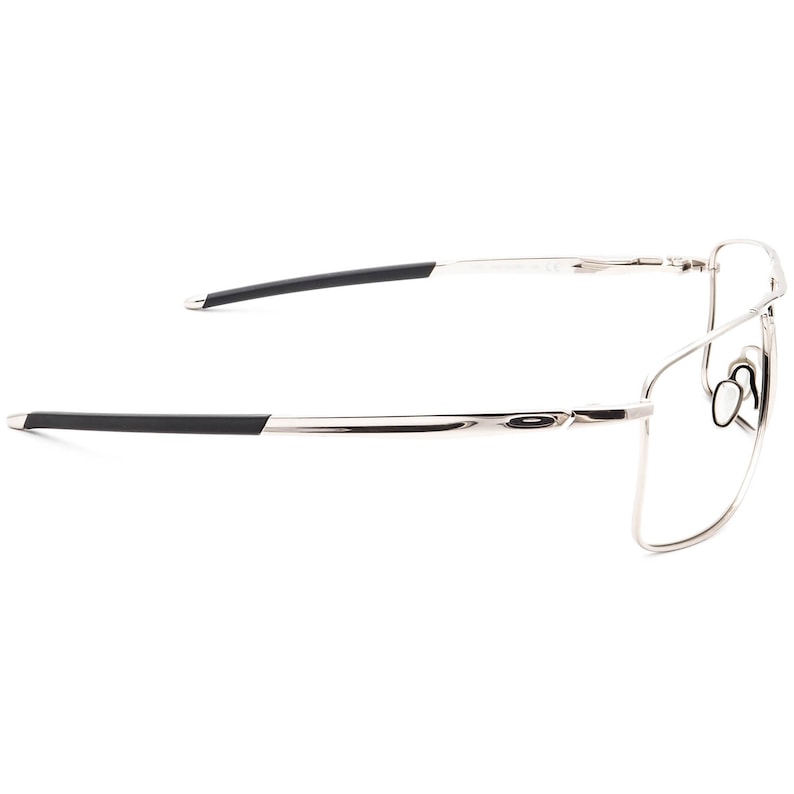 May include: Silver-toned metal frame eyeglasses with black temple tips. The glasses have a rectangular shape and a sleek, modern design.