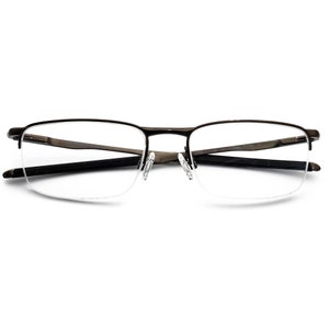 May include: A pair of black metal eyeglasses with a half-rim design and clear lenses. The glasses have a subtle curve to the frame.