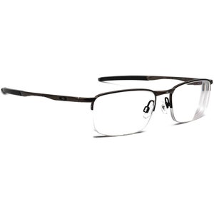 May include: A pair of brown metal frame eyeglasses with clear lenses. The glasses have a half-rim design with a thin metal bridge.