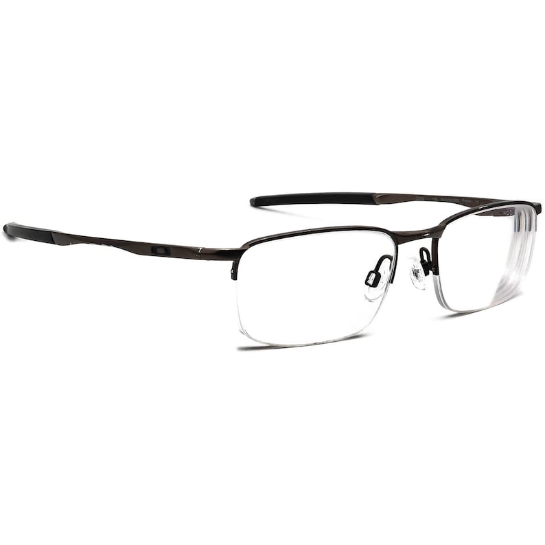 May include: A pair of brown metal frame eyeglasses with clear lenses. The glasses have a half-rim design with a thin metal bridge.
