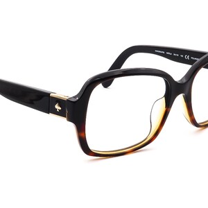 May include: Black and tortoise shell eyeglasses with a gold spade logo on the side. The glasses have a rounded square shape and clear lenses.