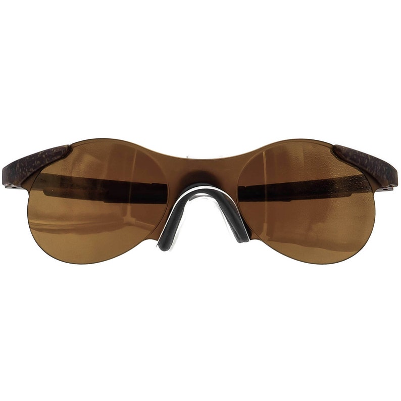 May include: Brown wraparound sunglasses with a dark brown lens.