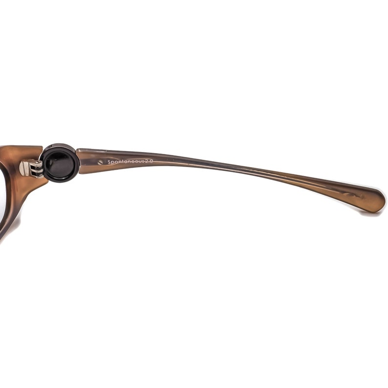 May include: A brown plastic frame with a black hinge and the text "Spoaleneous 2.0" on the side.