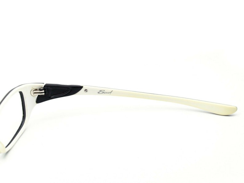 May include: White and black eyeglasses with the word "Scout" printed on the side.
