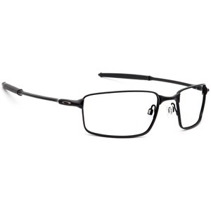 May include: Black rectangular frame eyeglasses with a thin metal frame and clear lenses.