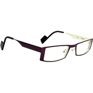 May include: Purple and silver rectangular eyeglasses with a thin metal frame and black arms. The brand name "TAGADA" is printed on the right arm.