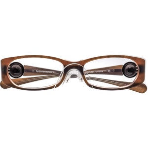 May include: Brown tortoiseshell eyeglasses with clear lenses and a clear nose bridge. The glasses have a black and silver detail on the arms and the text "Spontaneous 2.0" and "Wander Tortoise" on the arms.