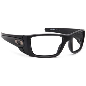 Puede incluir: Gafas de sol Oakley negras con lentes transparentes. Las gafas tienen una forma rectangular y una montura negra. El logotipo de Oakley es visible en el lateral de la montura.