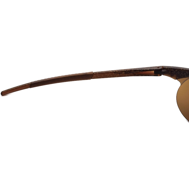 May include: Brown and gold-toned sunglasses with a flexible frame and a hinge in the middle of the arm.