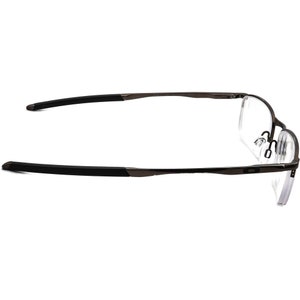 May include: A pair of black metal frame eyeglasses with clear lenses. The glasses have a thin, sleek design and are suitable for everyday wear.