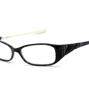 May include: Black and white patterned eyeglasses with a white temple arm.