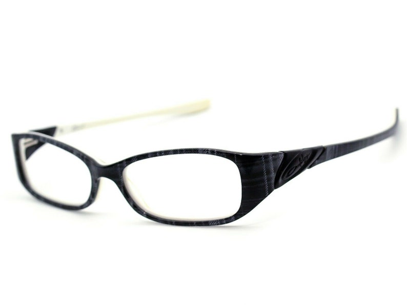 May include: Black and white patterned eyeglasses with a white temple arm.