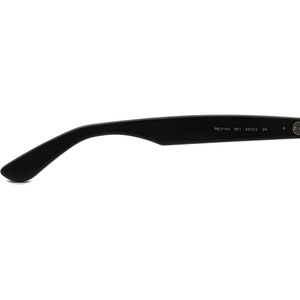 May include: Black plastic sunglasses with the text "RB 2140 901 50D22 3N" printed on the arm.