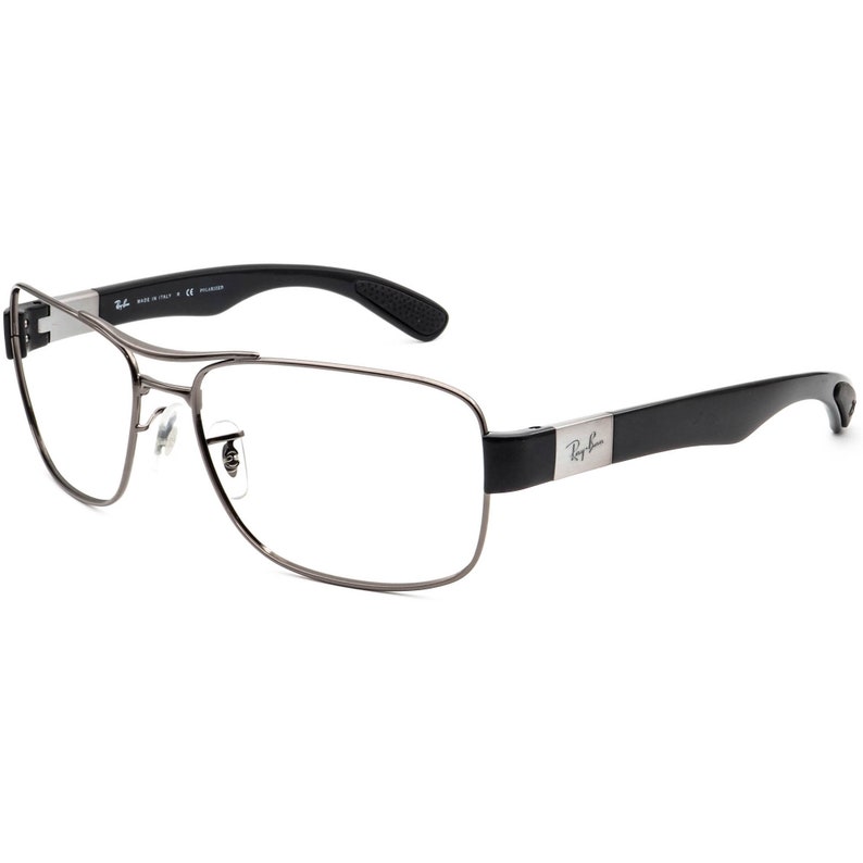 Puede incluir: Gafas rectangulares plateadas con patillas de pl&aacute;stico negro y la marca Ray-Ban en la patilla derecha.