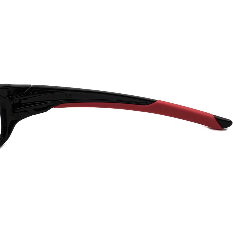 May include: Close-up of the black and red temple arms of a pair of sunglasses. The temple arms are made of a flexible material and have a CE marking.