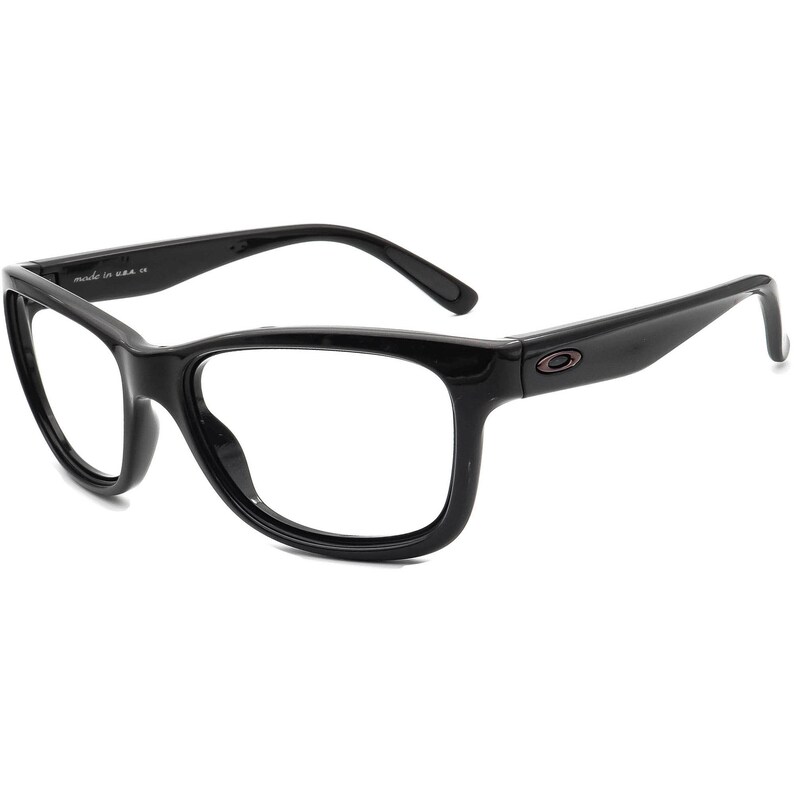 Op de afbeelding: Zwarte rechthoekige bril van plastic met heldere glazen. De merknaam "Oakley" is zichtbaar aan de zijkant van het montuur.