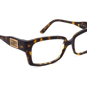 May include: Tortoise shell eyeglasses with a gold accent on the side. The glasses have a rectangular frame.
