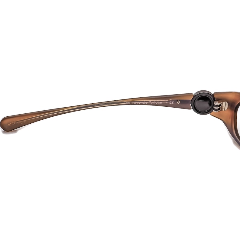 May include: Brown plastic framed glasses with a black temple tip and the text "448 lavender tortoise" on the arm.