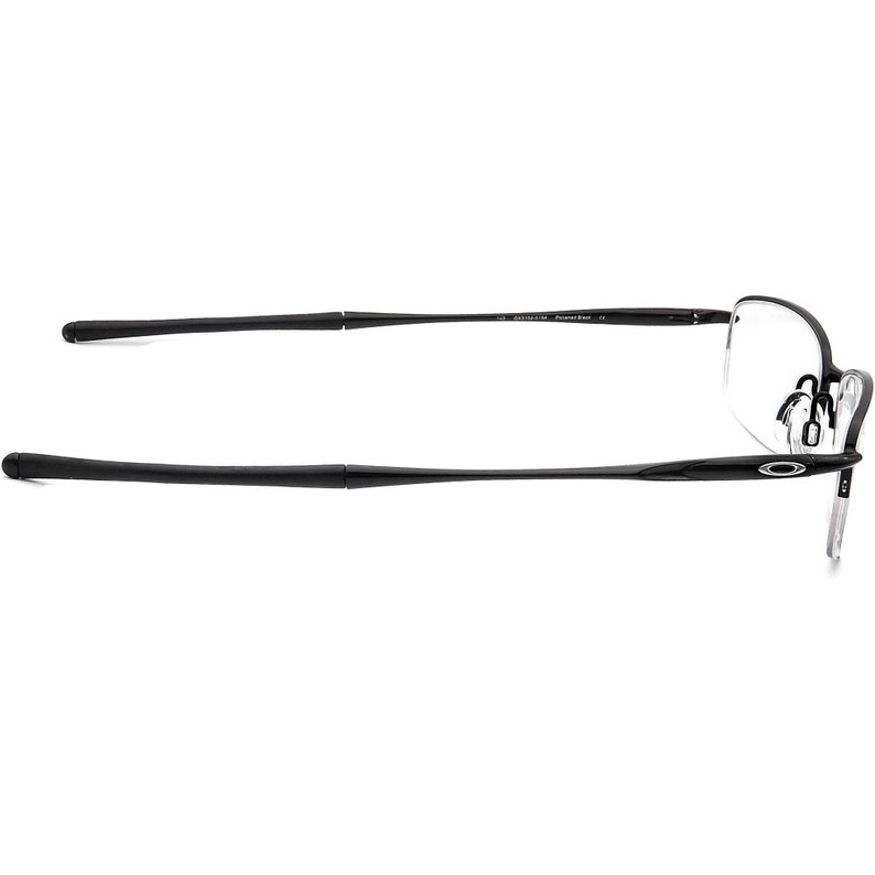 May include: Black metal frame spectacles with clear lenses. The frame has a thin, sleek design.