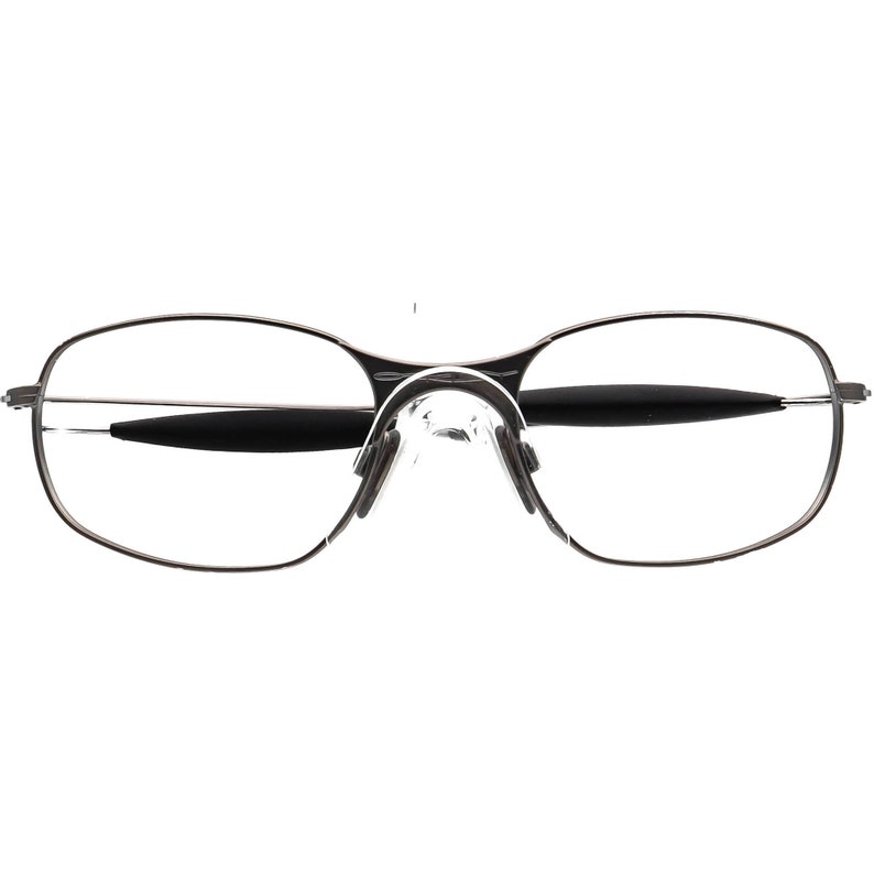 May include: A pair of rimless eyeglasses with a silver metal frame. The lenses are clear, and the nose pads are transparent. The temples have black accents. The overall design is sleek and modern.