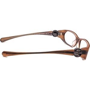 May include: Brown tortoiseshell glasses with a spring hinge on the right side. The glasses have a clear lens and the text "L/H Lavender Tortoise" is printed on the left arm.