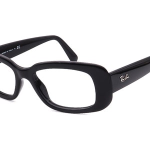 May include: Black rectangular frame eyeglasses with a Ray-Ban logo on the right temple.