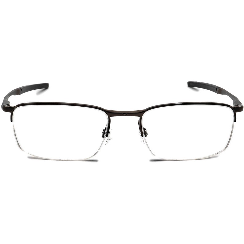 May include: A pair of brown metal eyeglasses with a half-rim design and clear lenses.