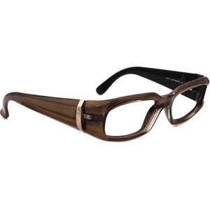 May include: Brown plastic framed glasses with a gold accent on the side. The glasses have a rectangular shape and clear lenses.