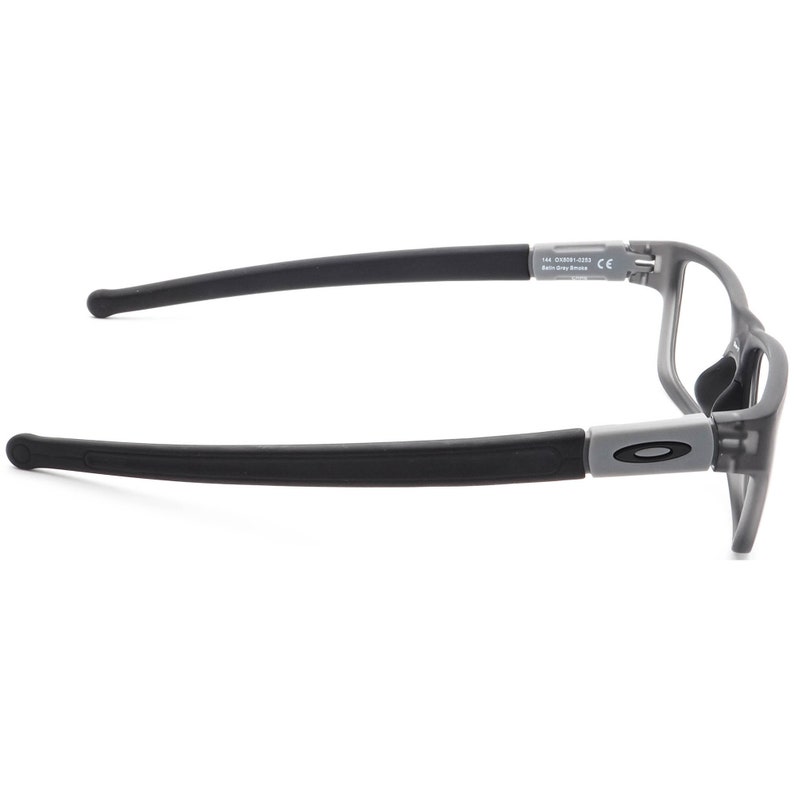 May include: Grey and black eyeglasses with a black rubber temple. The frame has a subtle curve and the text "Oakley" is visible on the side.