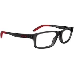 May include: Black rectangular eyeglasses with red accents on the arms. The frame is made of plastic and has a clear lens.