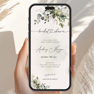 May include: A digital invitation for a bridal shower with a watercolor floral design in shades of green and white. The invitation reads "bridal shower" and includes the bride's name, date, time, location, and RSVP information. The text "registered at Amazon & Target" is also included.