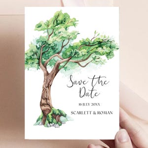 May include: Save the Date card with a watercolor illustration of a green tree with a brown trunk. The text reads "Save the Date" with the date "16 July 20XX" and the names "Scarlett & Roman".