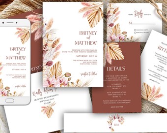 May include: A collection of wedding stationery featuring a floral design with pampas grass and orchids. The set includes invitations, reply cards, details cards, and a reception card. The color palette is a mix of brown, beige, and pink.