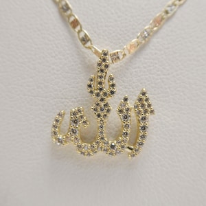 May include: A gold necklace with a pendant featuring the Arabic word "Allah" in a stylized design, set with clear cubic zirconia stones.