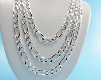 May include: Three silver chains with a figaro link pattern, displayed on a white mannequin bust.