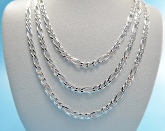 May include: Three silver chain necklaces of different lengths and widths, displayed on a white mannequin bust.