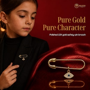 May include: A polished 10K gold safety-pin brooch featuring a dangling eye-shaped charm. The charm is encrusted with small white stones and a single blue stone in the center. The text on the image reads Pure Gold Pure Character Polished 10K gold safety-pin brooch.