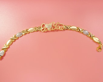 Pulsera "Te amo XO" de plata de ley con acabado bicolor en oro de 14k.