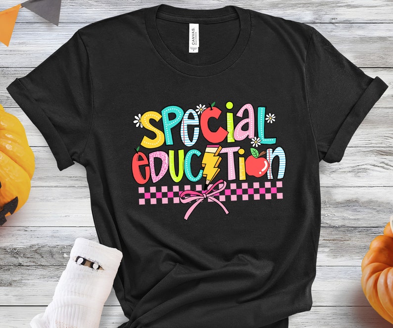 May include: Black t-shirt with the text "Special Education" in colorful letters with a pink bow and checkered pattern.