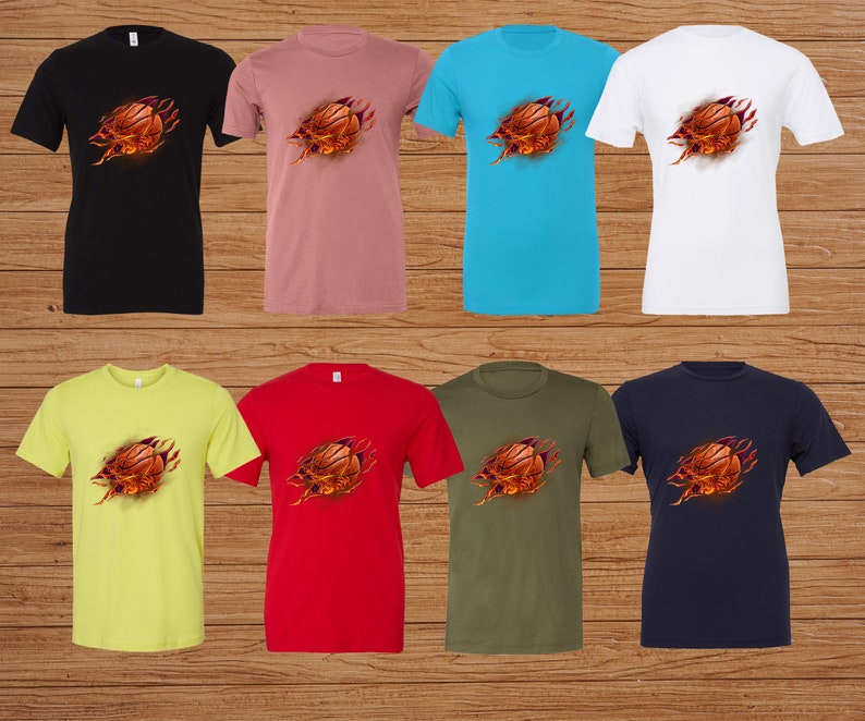 May include: A set of ten t-shirts featuring a basketball bursting through the fabric. The shirts are in various colors, including black, pink, blue, white, yellow, red, green, and navy.