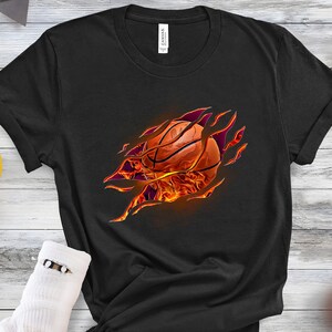 May include: Black t-shirt with a graphic of a basketball bursting out of the fabric, with flames around it.