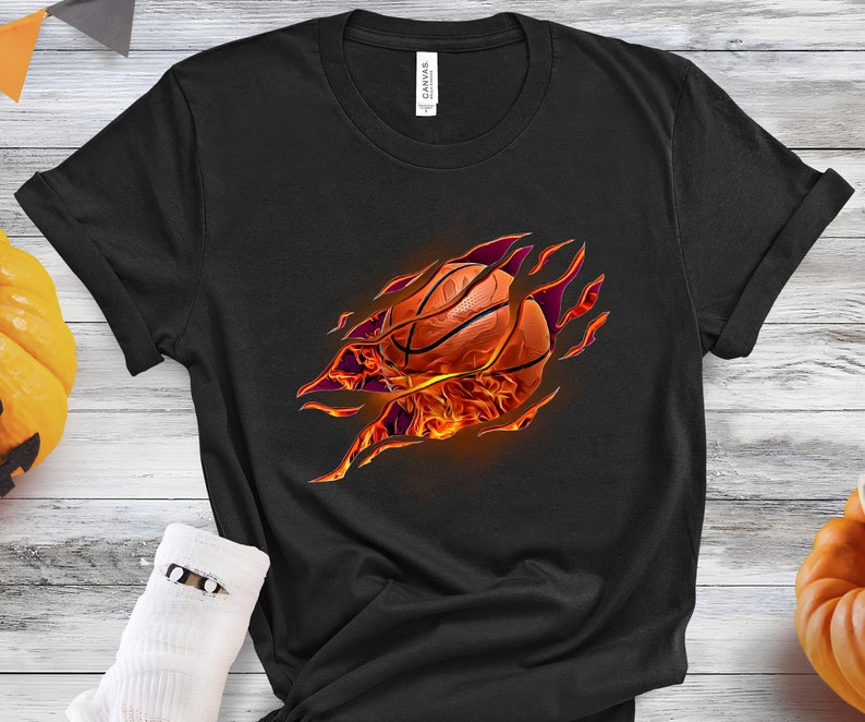 May include: Black t-shirt with a graphic of a basketball bursting out of the fabric, with flames around it.