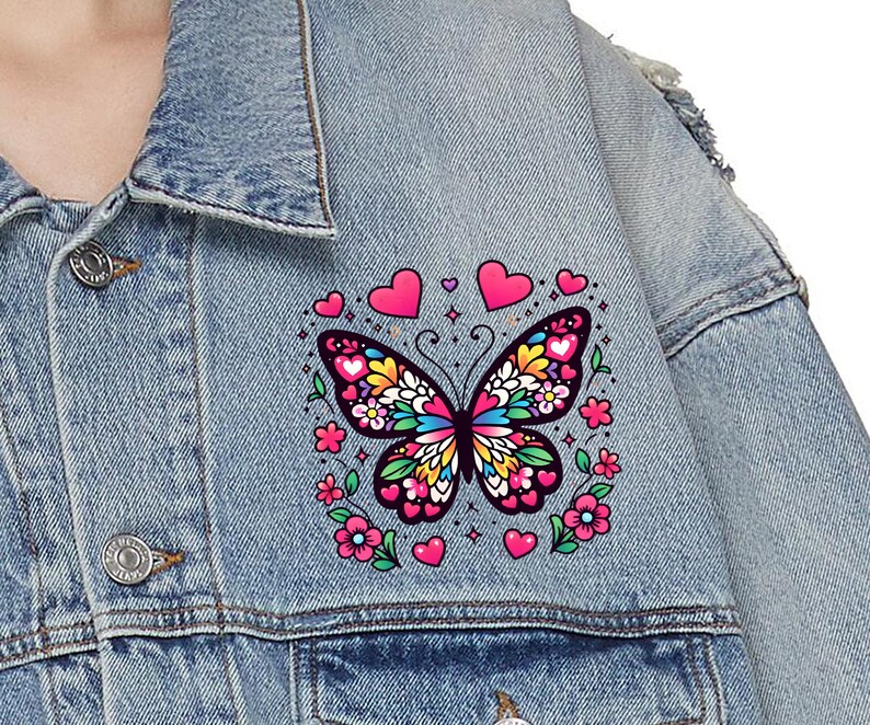 May include: A blue denim jacket with a colorful butterfly patch. The butterfly is surrounded by pink hearts and flowers.