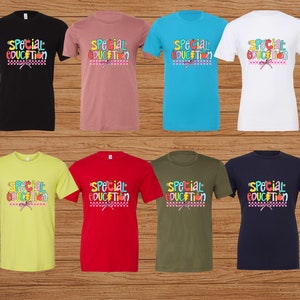 May include: Eight different color t-shirts with the text "Special Education" in colorful letters and a graphic of school supplies and a bow. The shirts are displayed on a wood background.