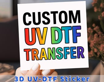 May include: A white square card with the words "CUSTOM UV DTF TRANSFER" in large, bold, black letters. The letters "UV DTF" are in a rainbow gradient. Below, the text "3D UV-DTF Sticker" is in blue.