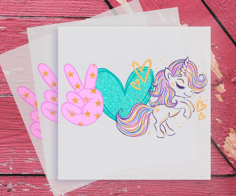 May include: Peace, love, and a unicorn graphic with pink peace signs, a teal heart, and a rainbow unicorn with gold glitter accents.
